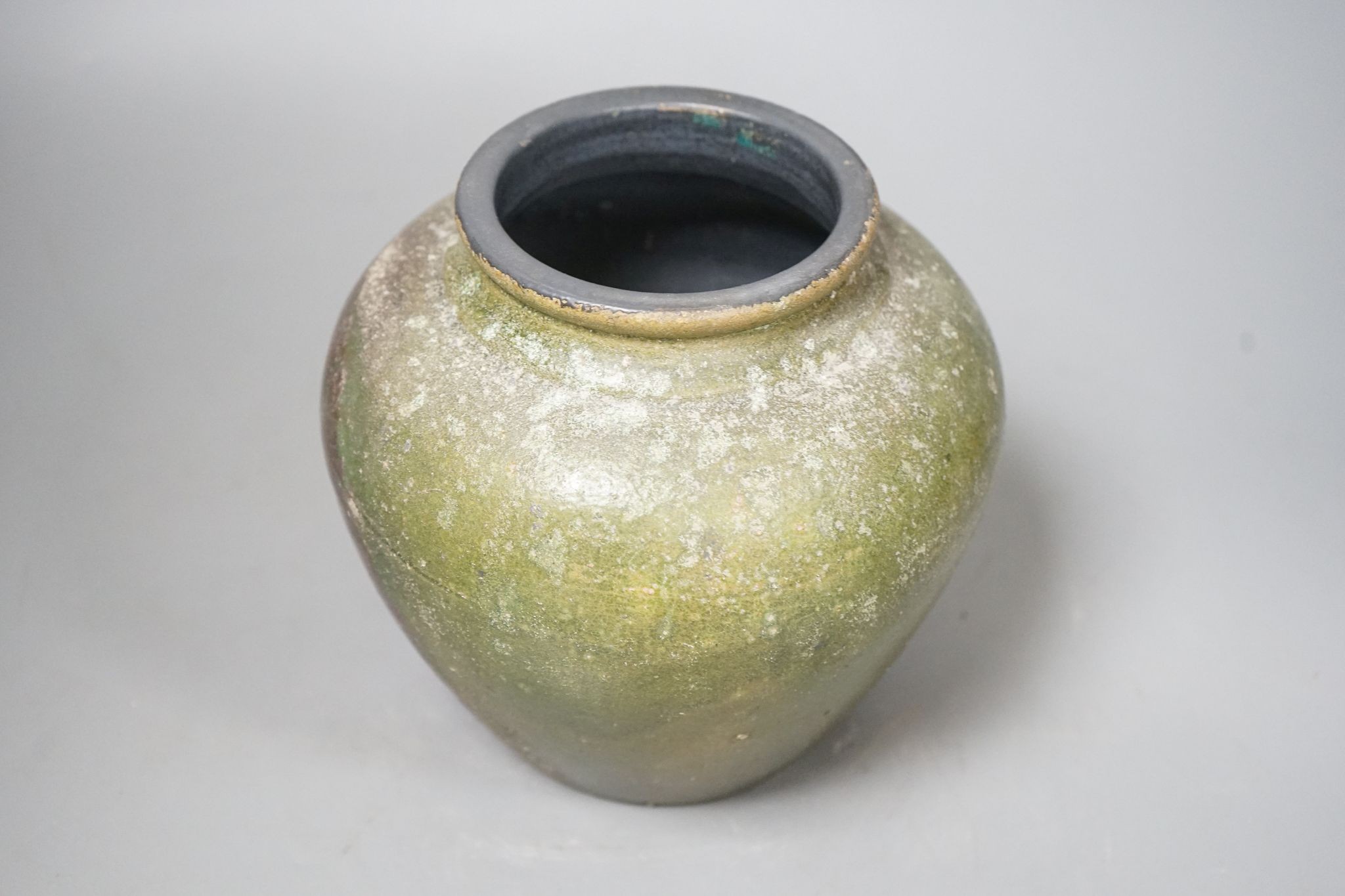 A copper lustre and green glazed pottery jar, 17.5cm high